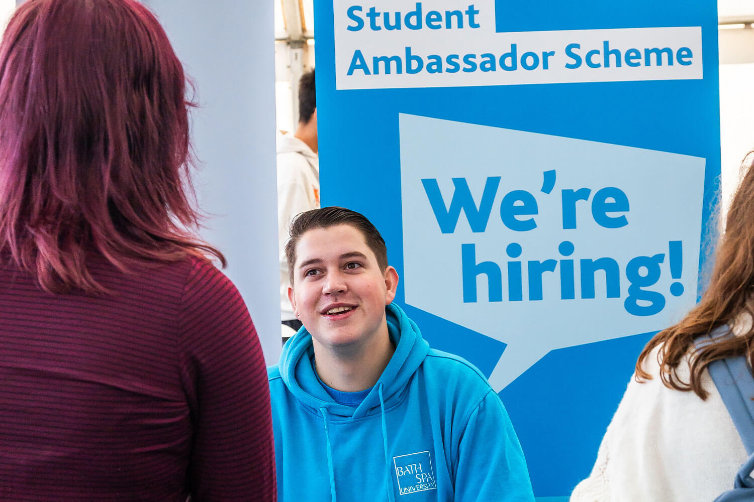 Student Ambassador staffing a hiring stand at a jobs fair